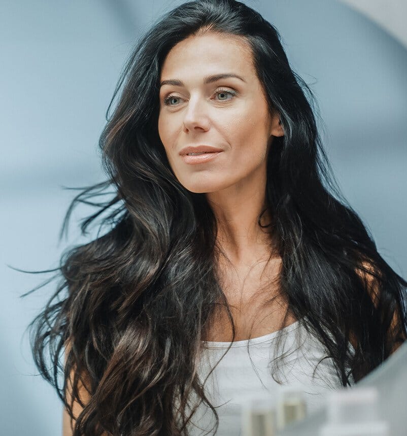 woman looking at herself in a mirror in a bathroom