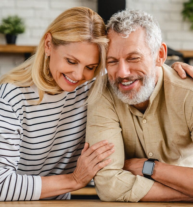 smiling couple sitting at a table