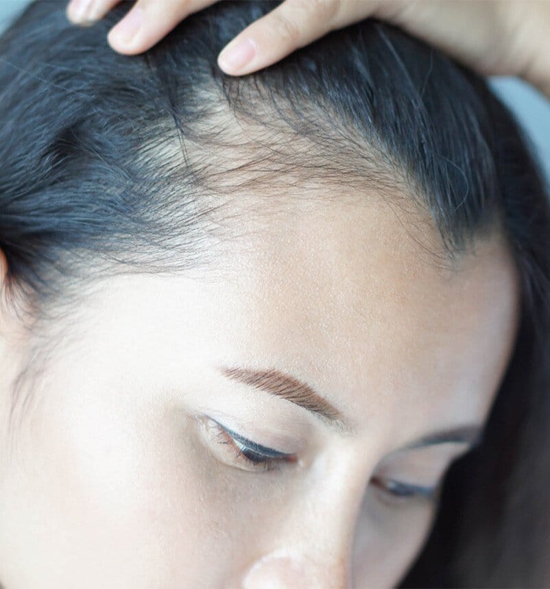 woman touching her hair
