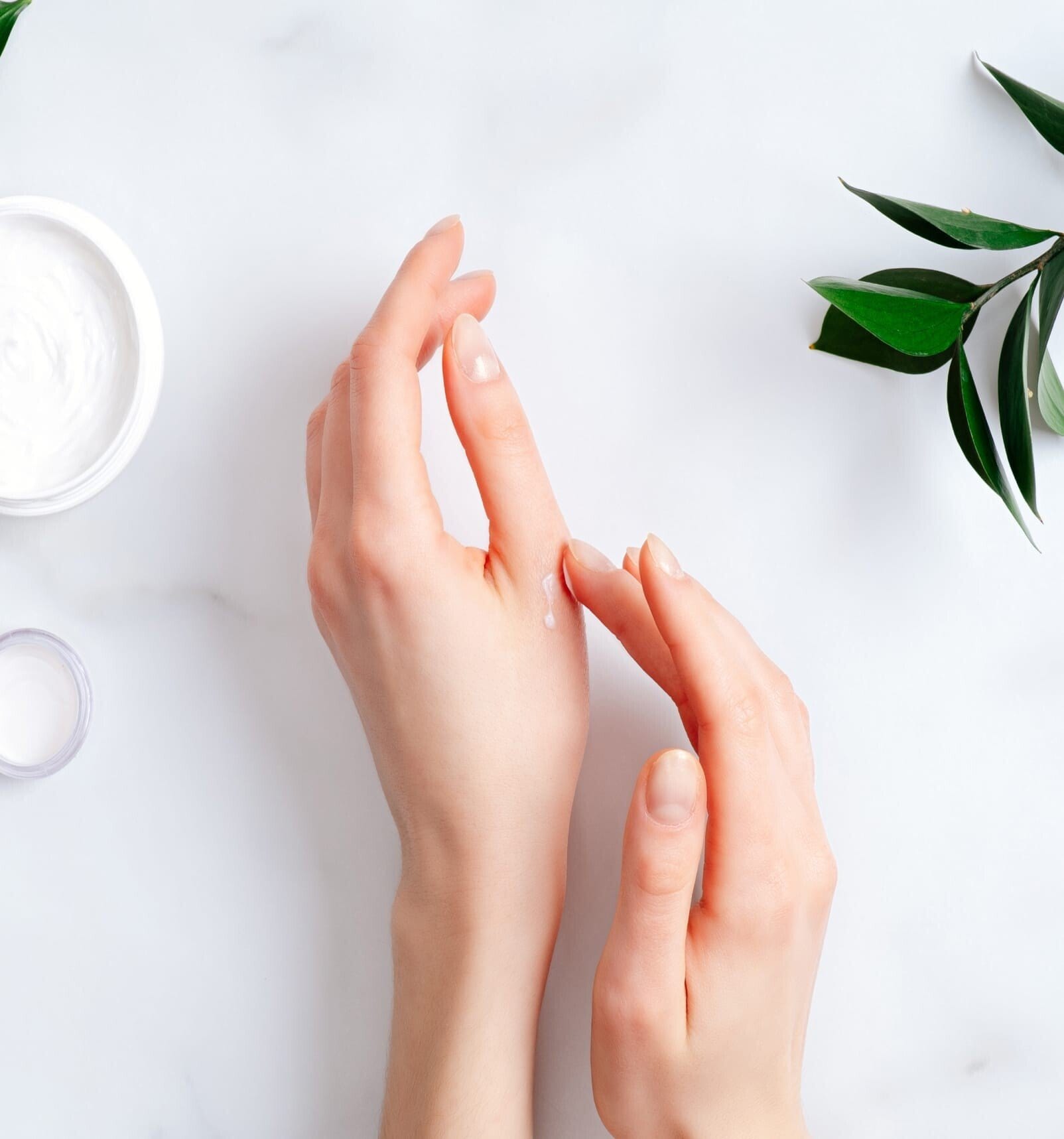 Hands putting on hand cream