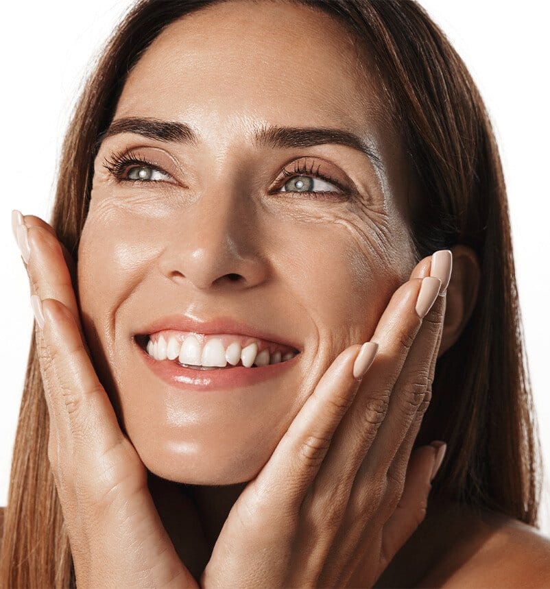 smiling woman with hands on face and hands on chin