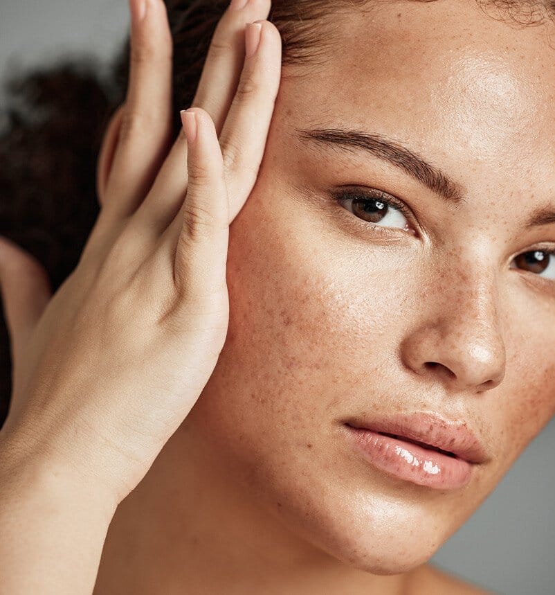 there is a woman that is touching her face with her hand