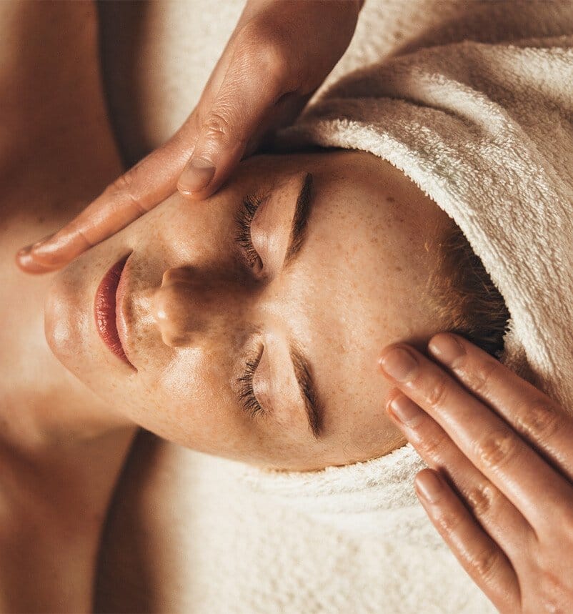 someone is getting a facial massage at the spa