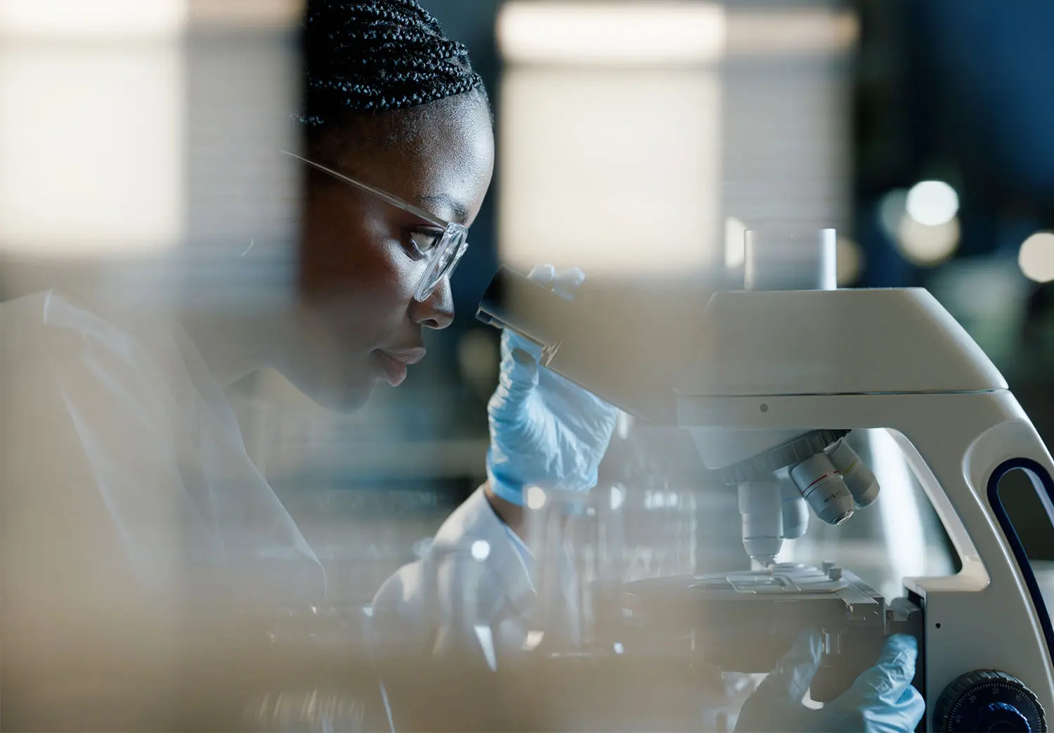 A woman in a healthcare lab performing research.
