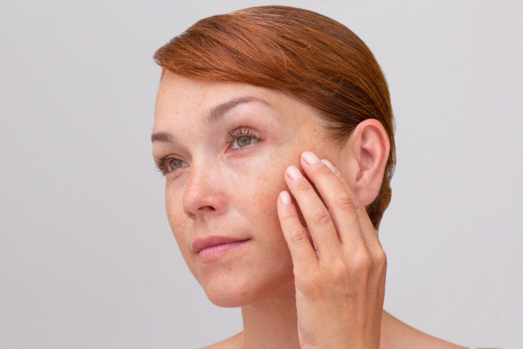 Middle-age woman touching face