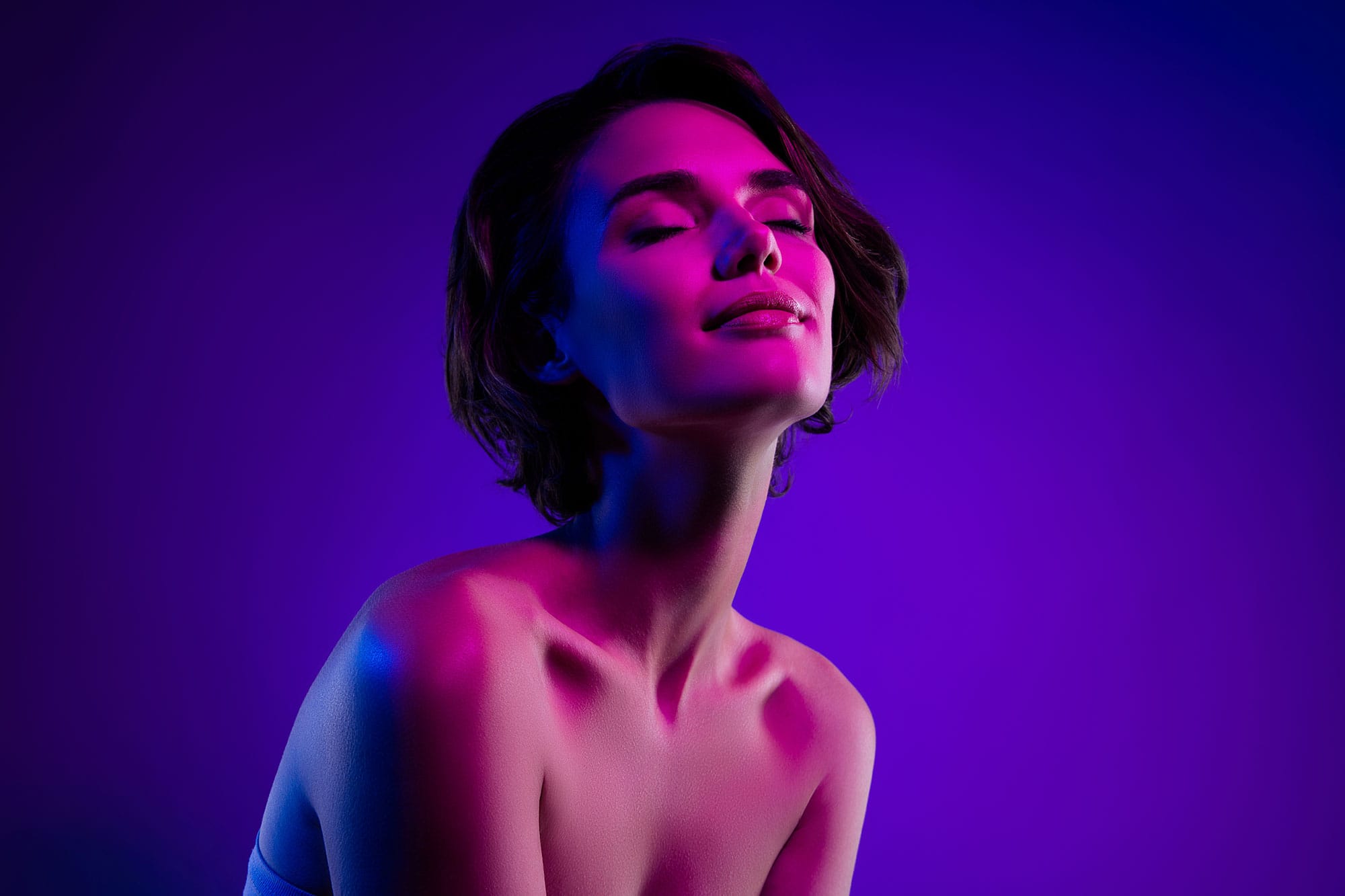 Woman with excellent skincare radiating purple and pink colors