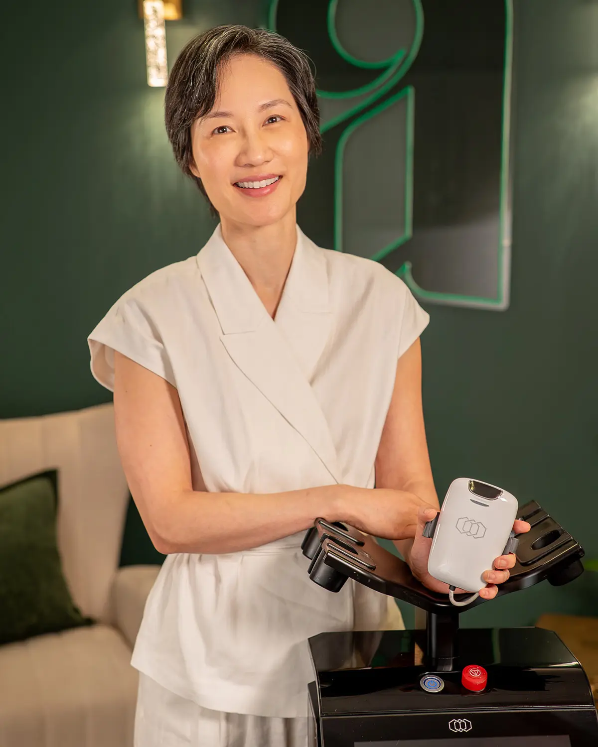 Dr. Melissa Chiang smiling with Tone by InMode device