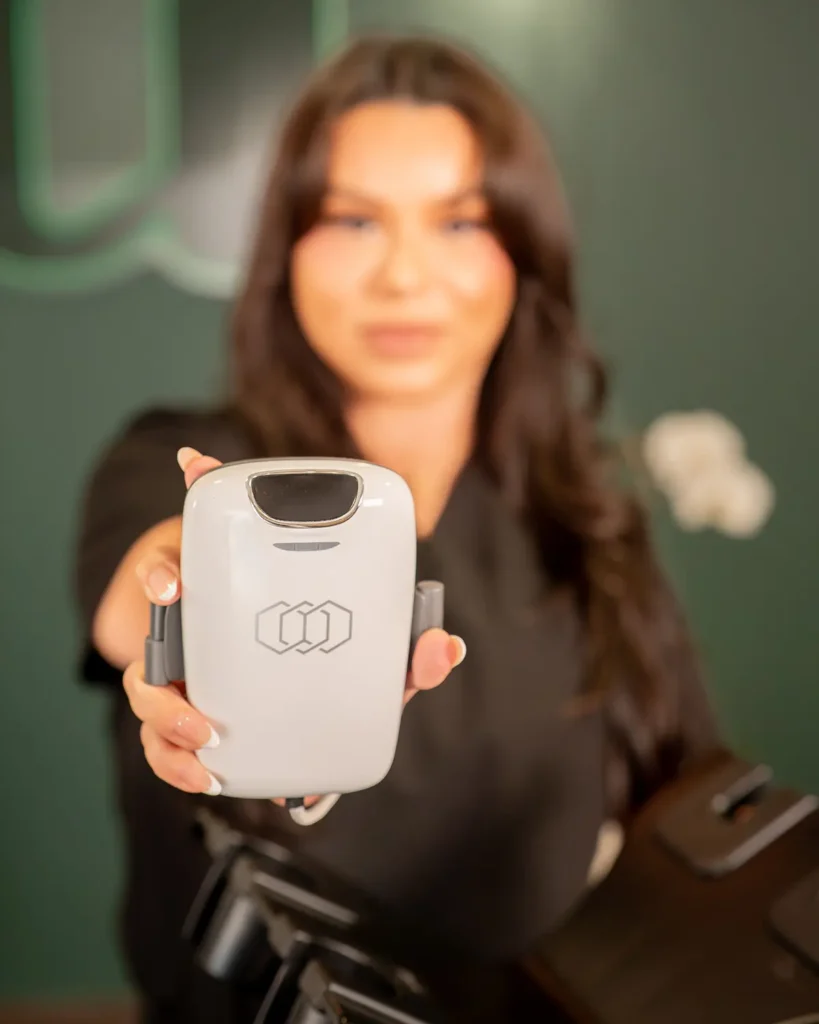 Integrated Aesthetics staff holding Tone by InMode device