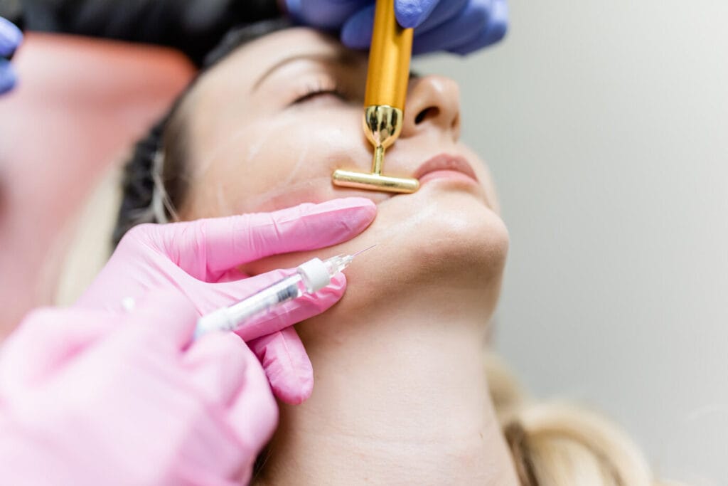 Dr. Melissa Chiang performing a dermal filler treatment on a female patient in The Woodlands, TX.